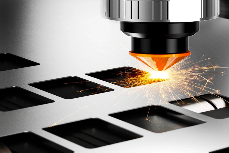 graphic showing laser head over a metal sheet with a grid of cut squares