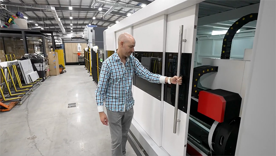 Danny Martinez inside the EMP Warehouse, demonstrating an EMP laser cutter